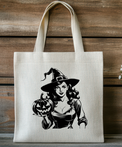 Tote bag with a Halloween design of a witch holding a pumpkin against a wooden background