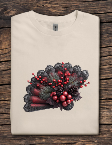 Folded beige t-shirt with a decorative design of red berries and black lace on a wooden surface