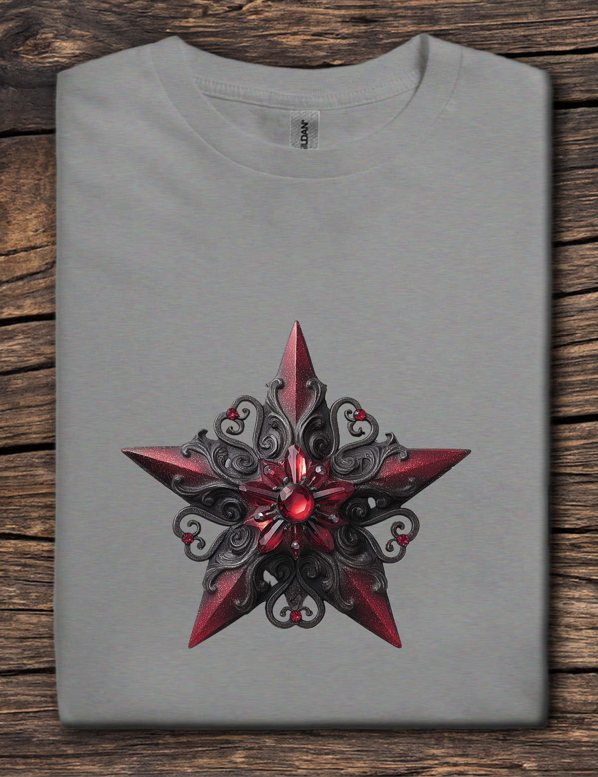 Gray t-shirt with a red and black star design on a wooden surface