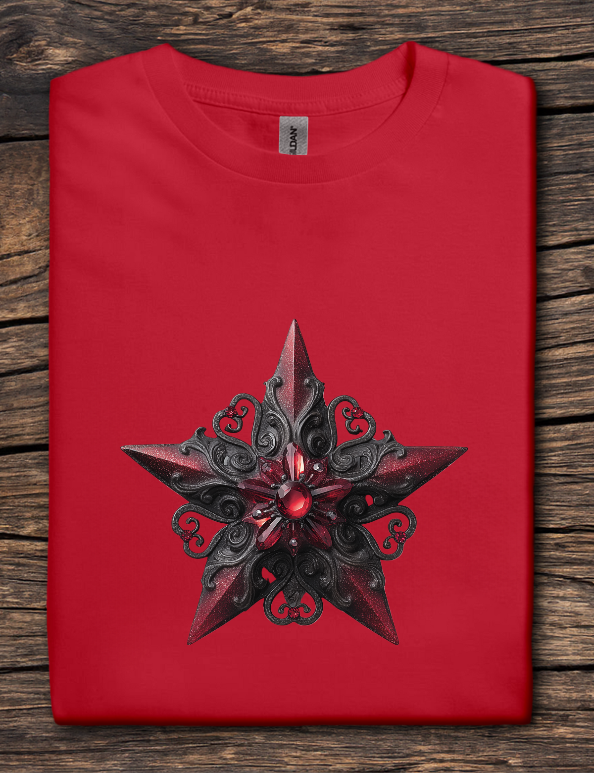 Red t-shirt with a black and red star design on a wooden surface
