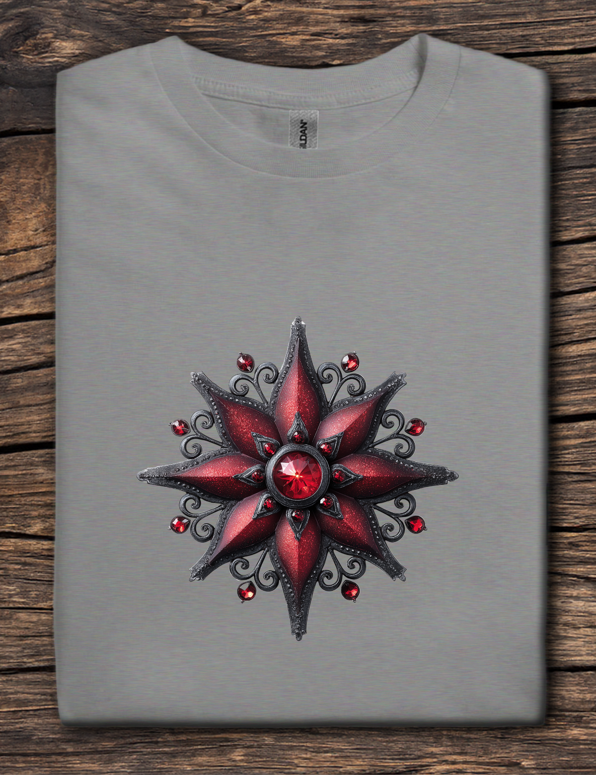 Gray t-shirt with a red and black star design on a wooden surface