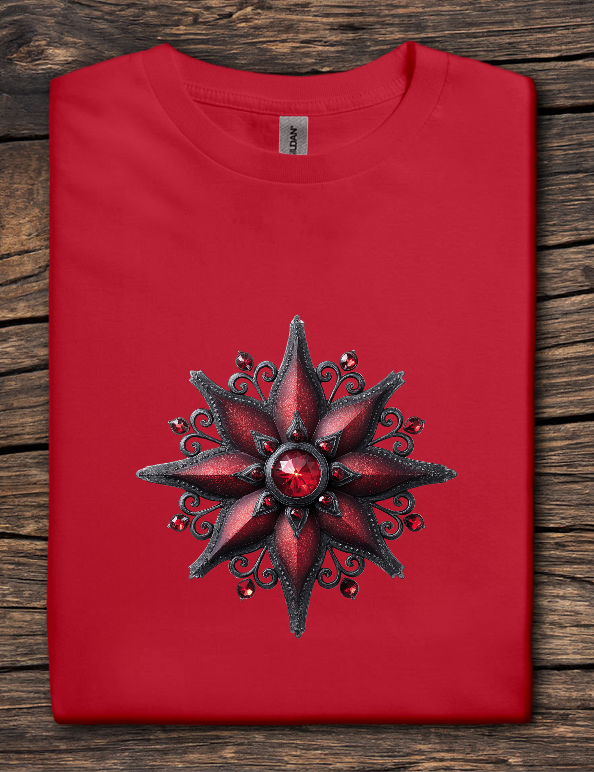 Red t-shirt with a decorative star design on a wooden surface