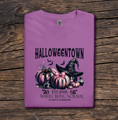 Purple t-shirt with Halloween-themed design on a wooden surface