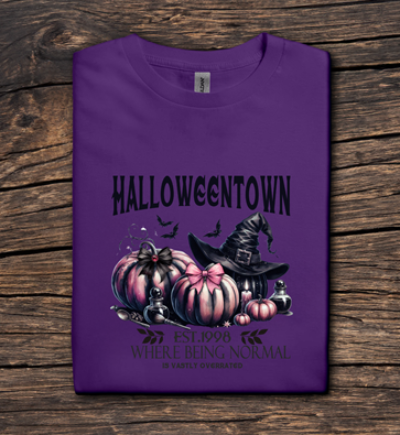 Purple t-shirt with Halloween-themed design on a wooden surface