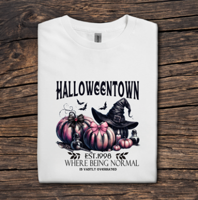 White t-shirt with Halloween-themed design on a wooden surface