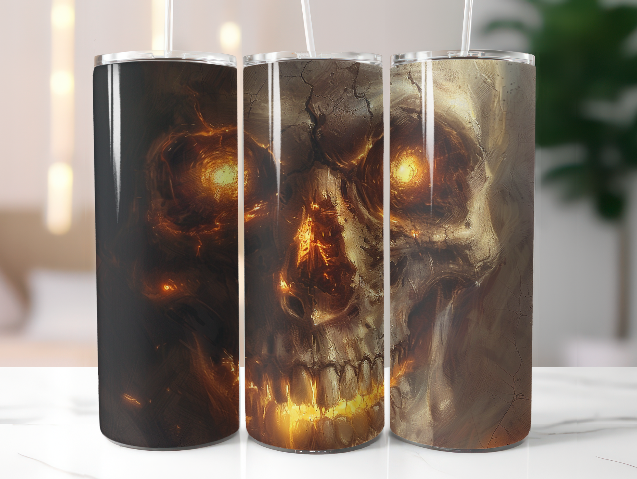 Three tumblers with skull designs on a white surface.