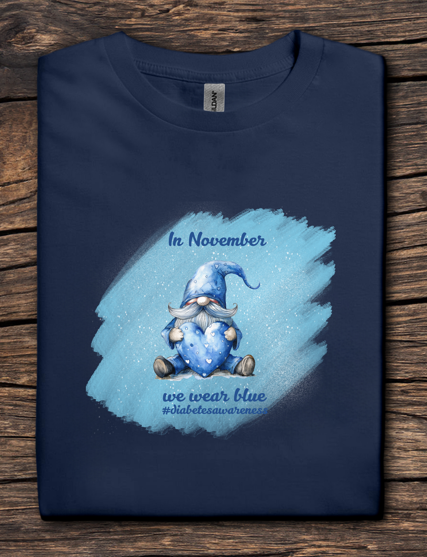 Navy blue t-shirt with a blue gnome graphic and text on a wooden surface
