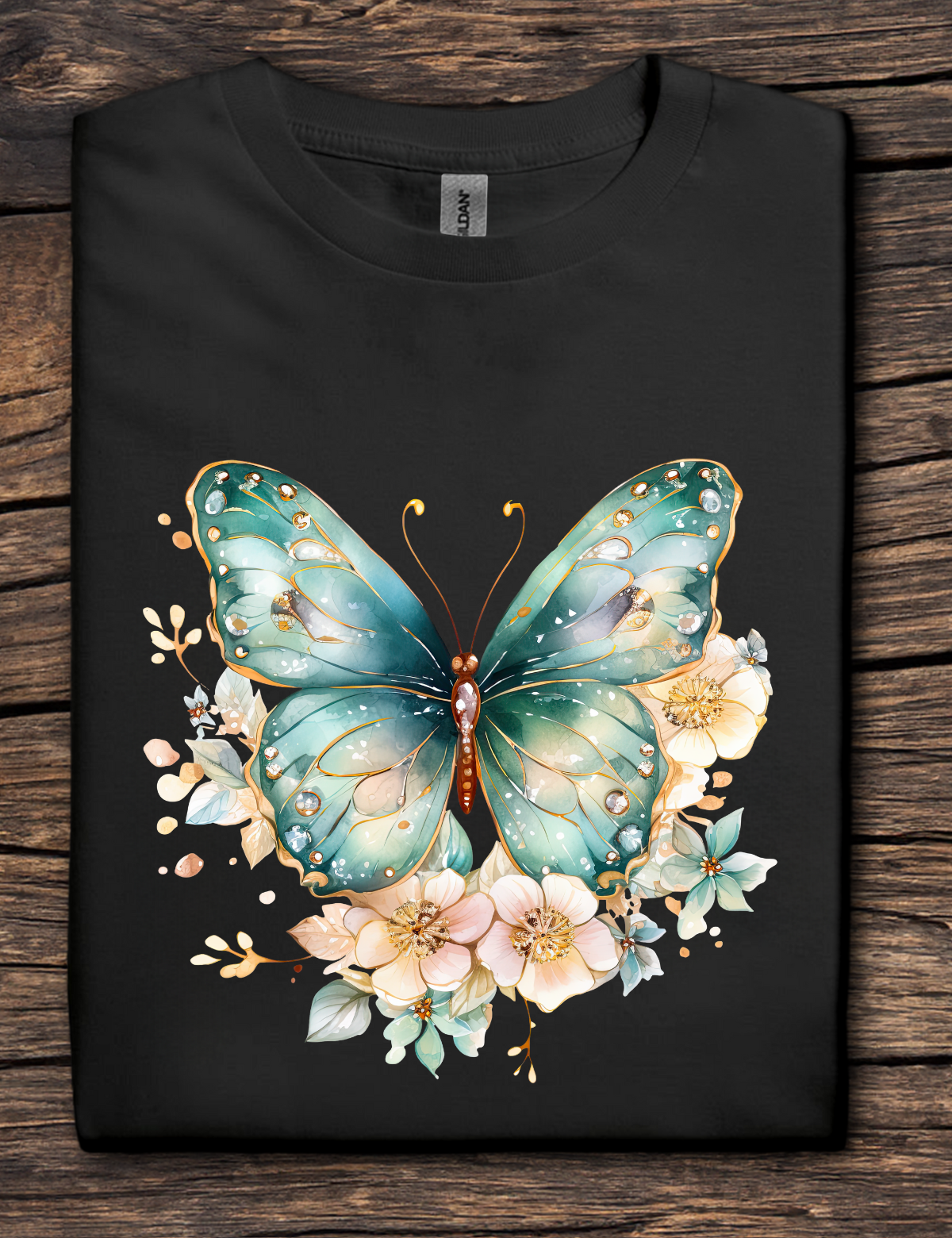 Black t-shirt with a colorful butterfly and floral design on a wooden surface