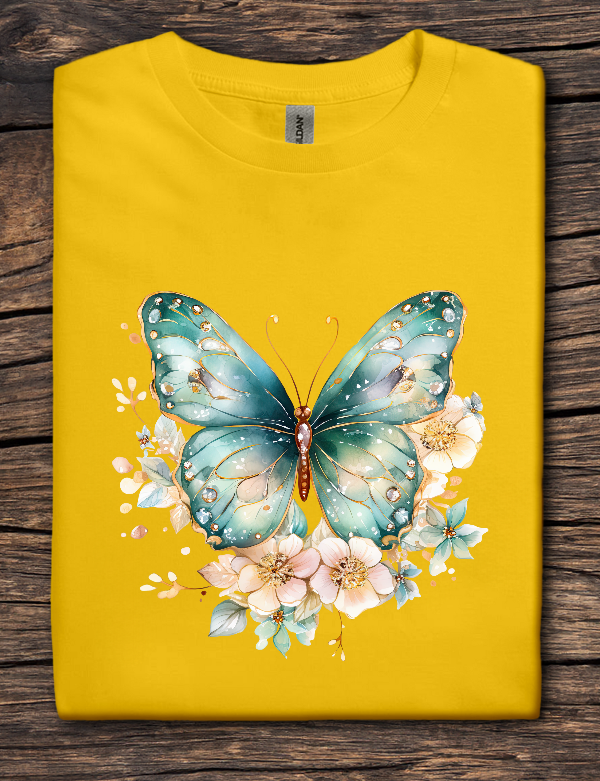 Yellow t-shirt with a blue butterfly and floral design on a wooden surface