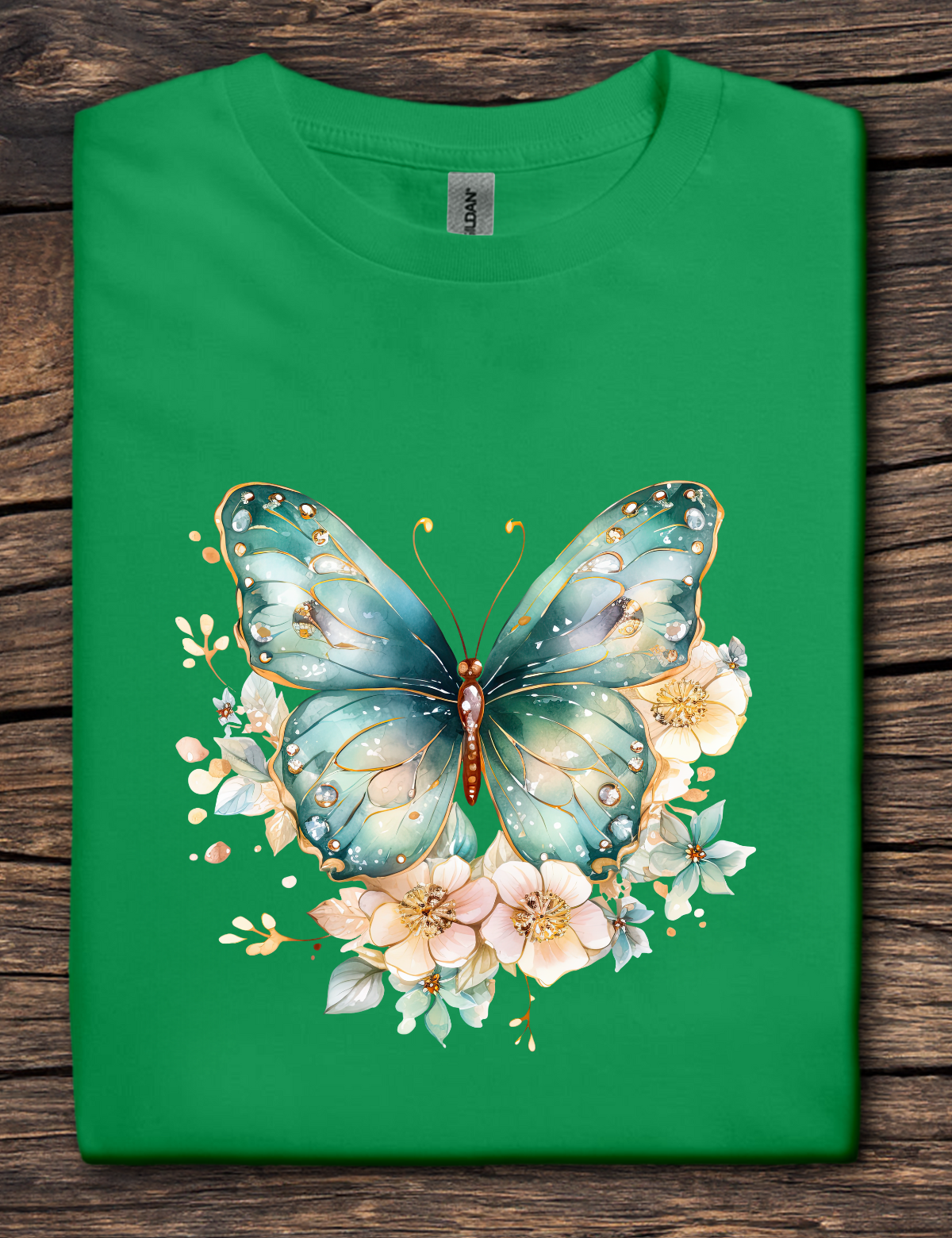 Green t-shirt with a butterfly and floral design on a wooden surface