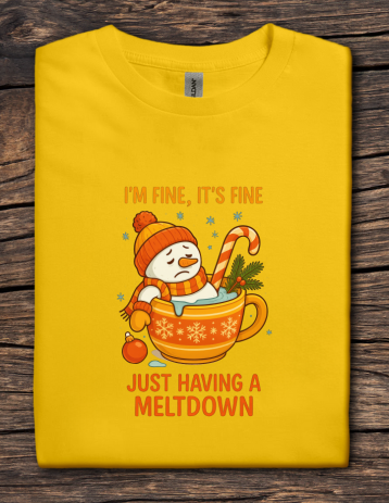 Yellow t-shirt with a snowman graphic and text on a wooden surface