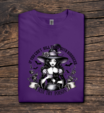 Purple t-shirt with a witch graphic and text on a wooden surface