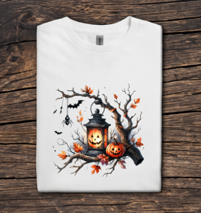 White t-shirt with Halloween-themed design featuring pumpkins and a lantern on a wooden surface.