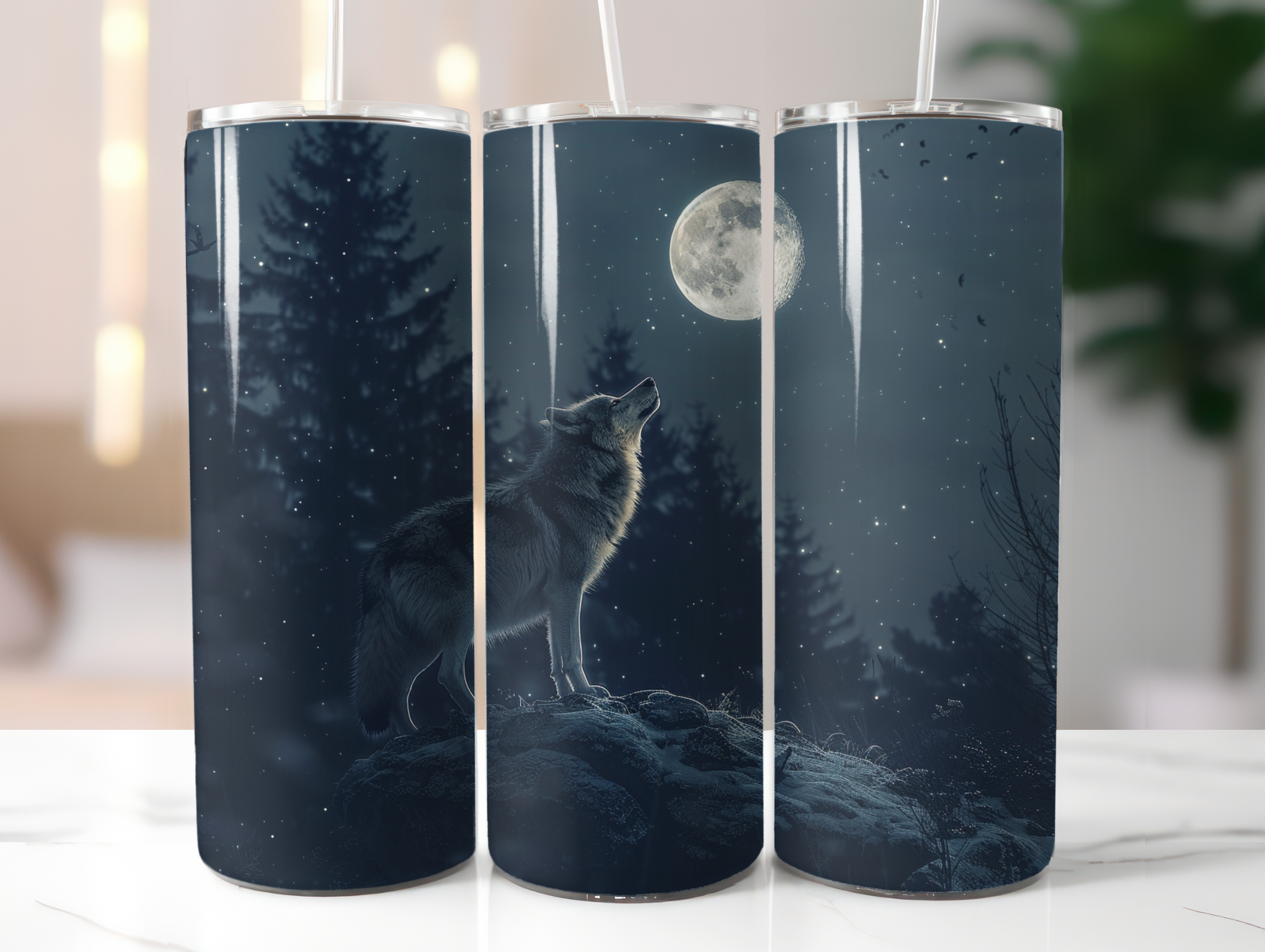 Three tumblers with a wolf howling at the moon design on a white surface.