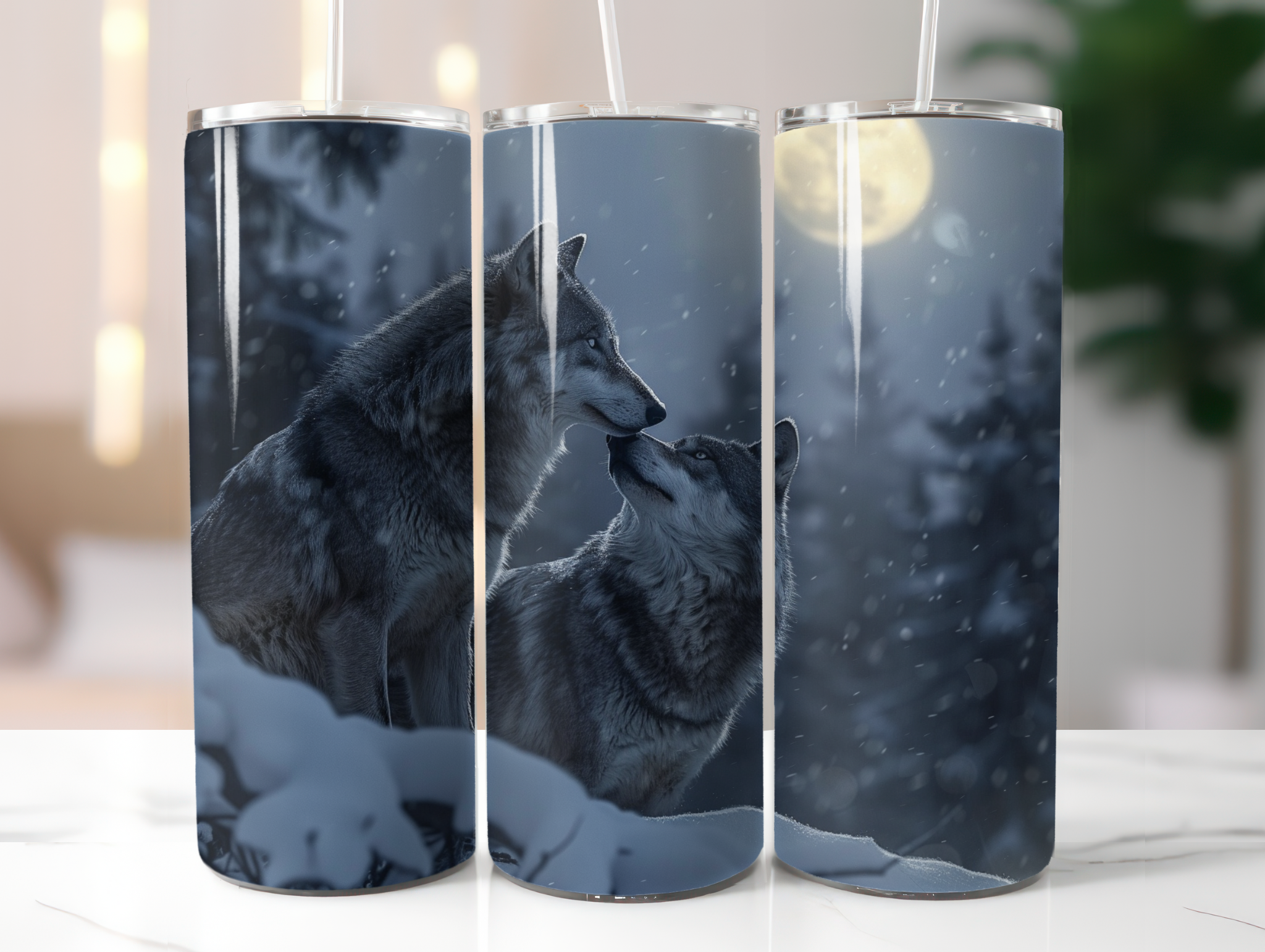 Three tumbler cups with wolf design on a white surface.