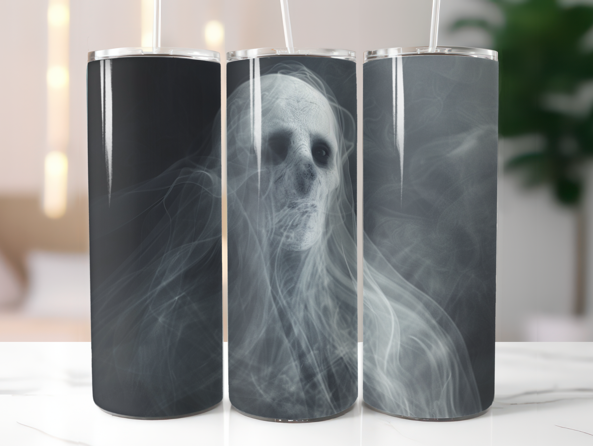 Three tumblers with a ghostly skeleton design on a white surface.
