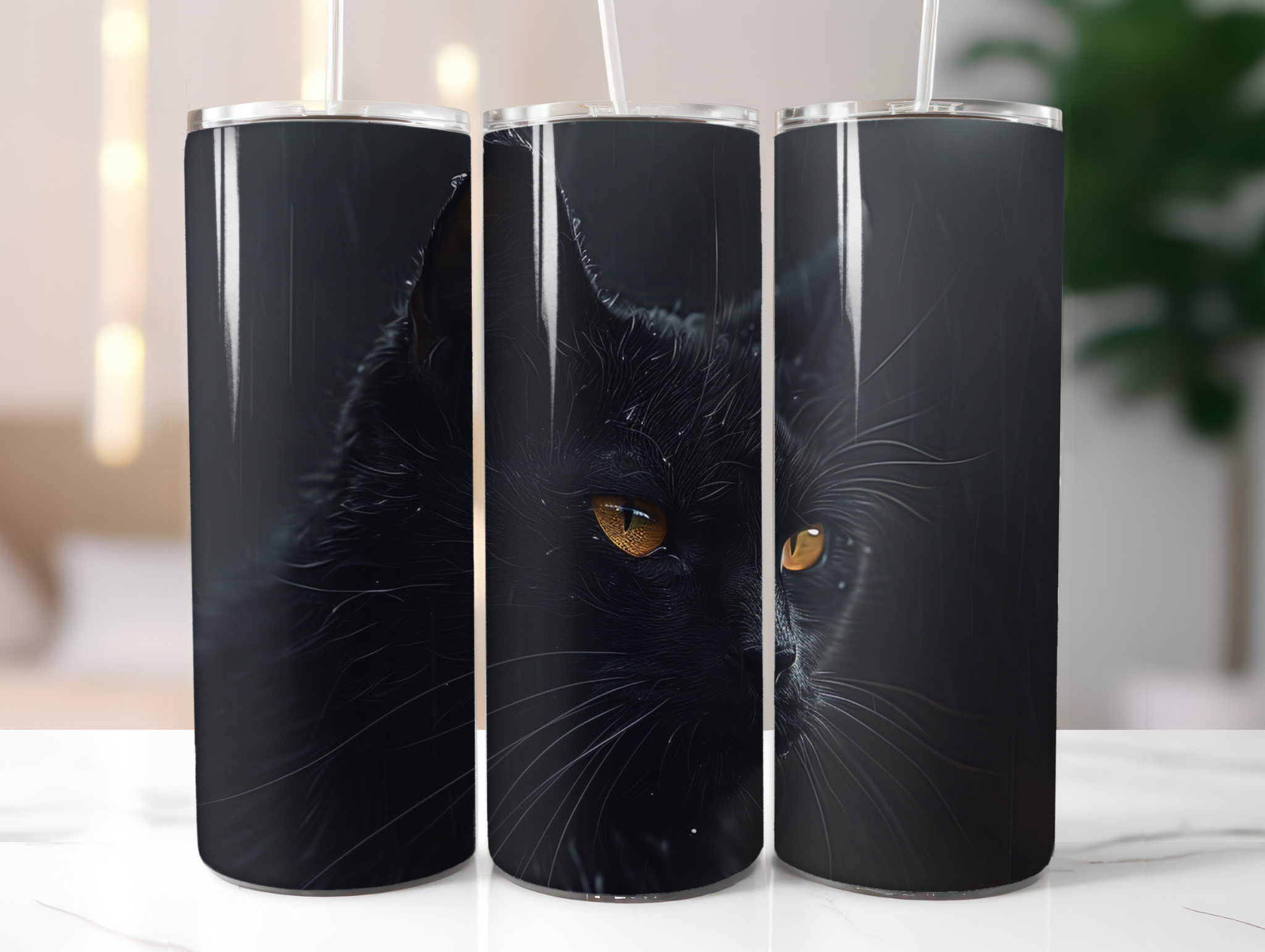 Three black tumblers with a cat design on a white surface.