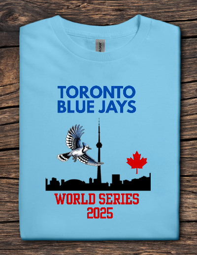 Light blue t-shirt with Toronto Blue Jays World Series 2025 design on a wooden surface