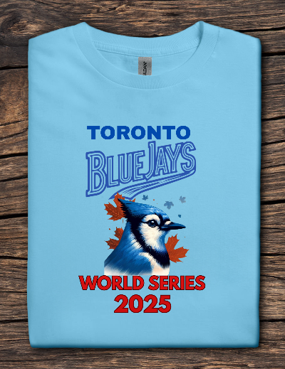 Light blue t-shirt with Toronto Blue Jays World Series 2025 design on a wooden surface