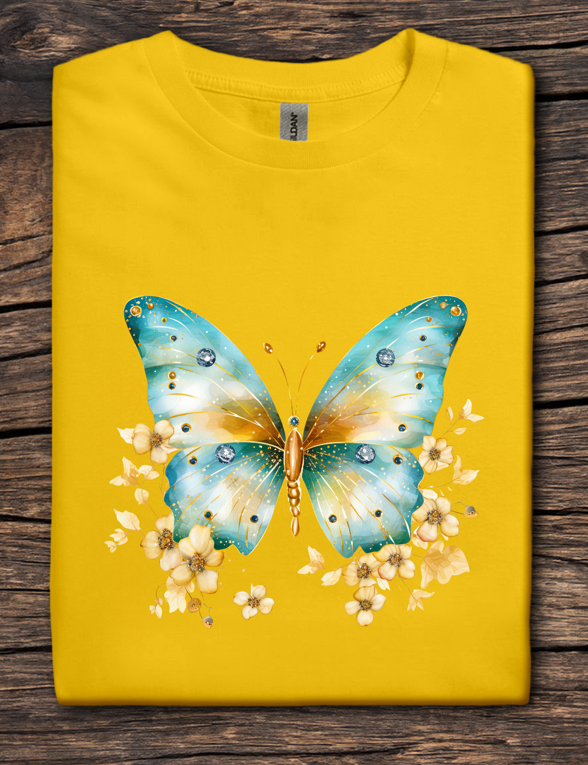 Yellow t-shirt with a blue butterfly design on a wooden surface
