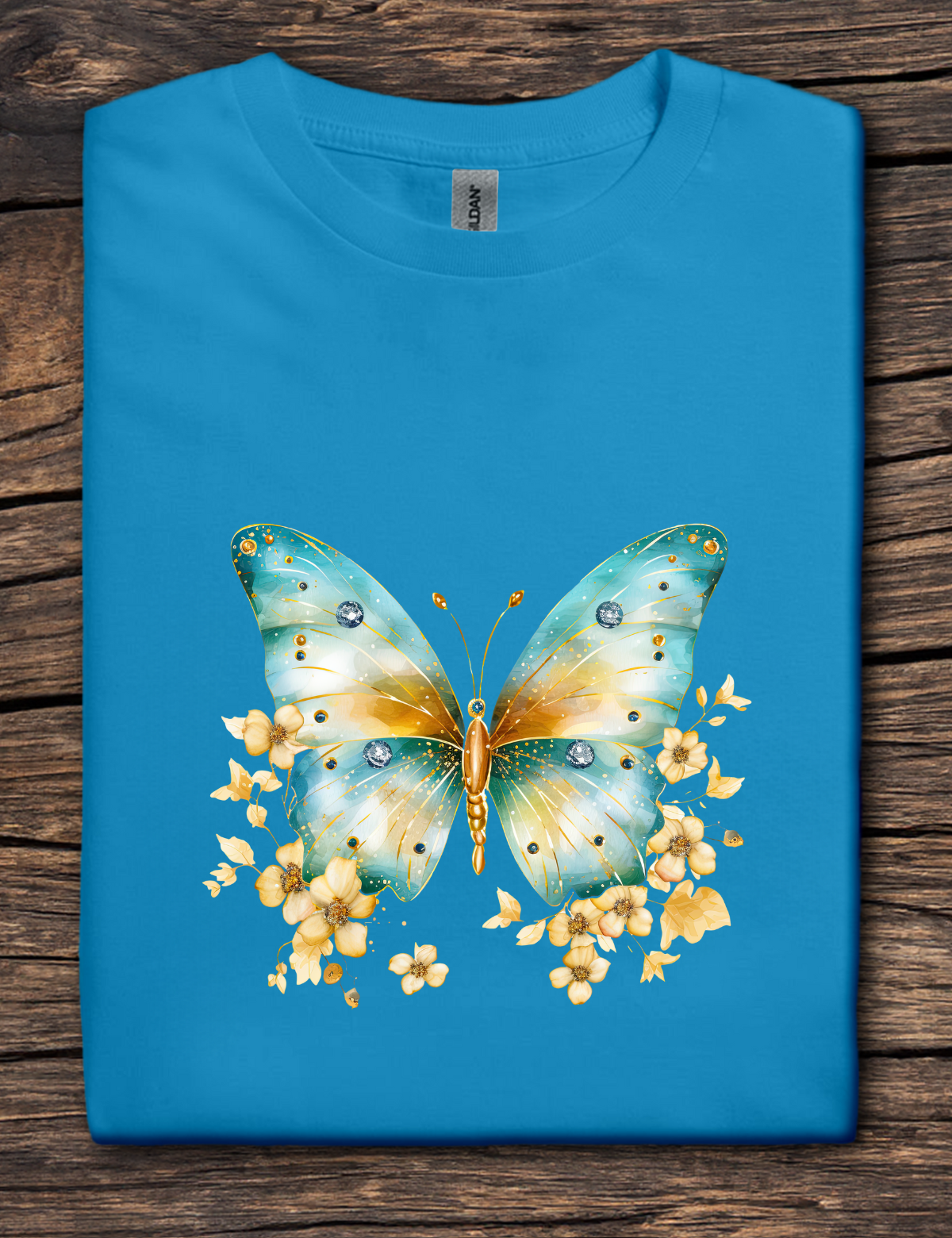 Blue t-shirt with a colorful butterfly design on a wooden surface