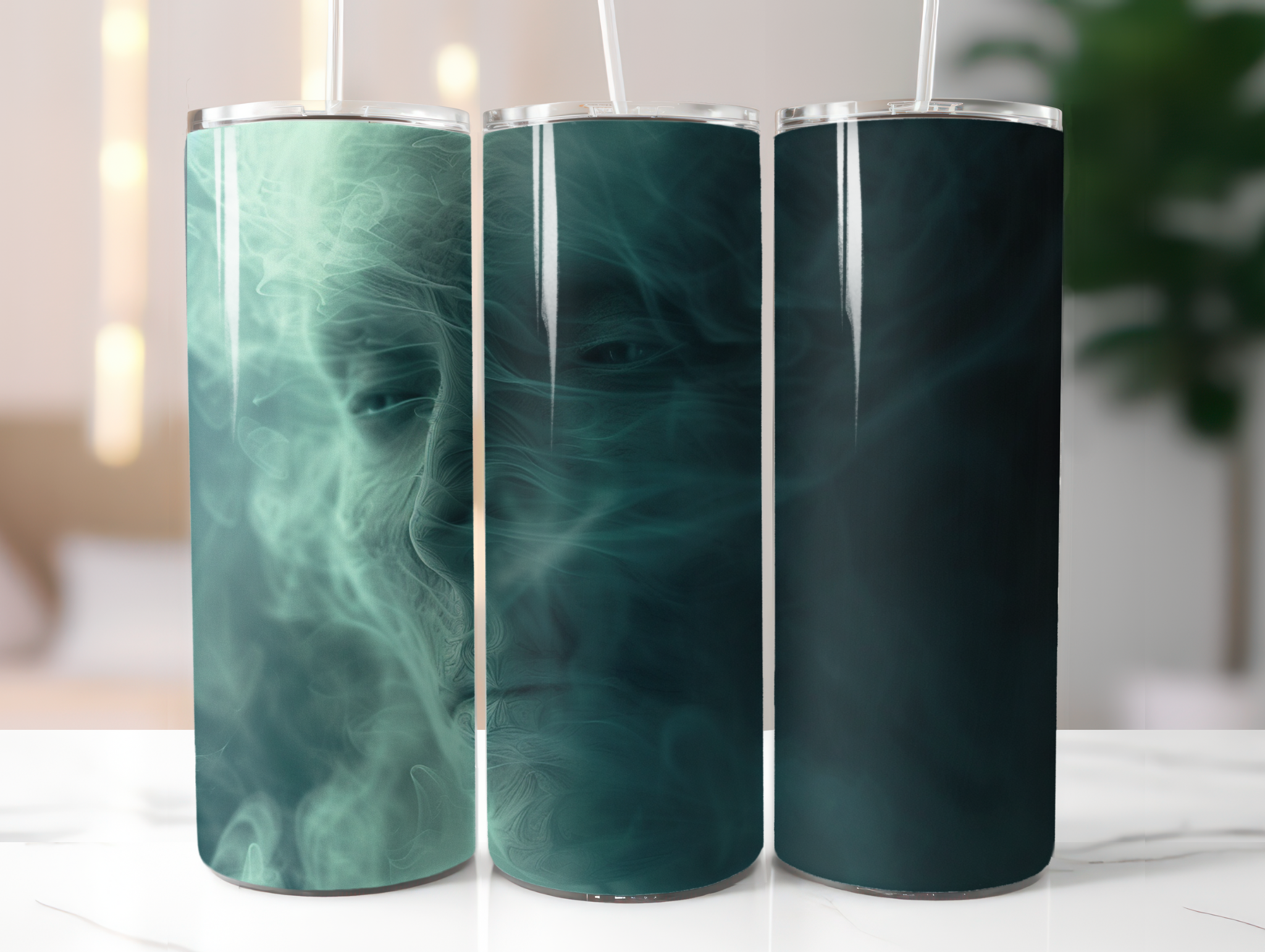 Three teal-colored tumblers with a marbled design on a white surface.